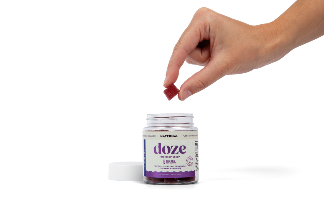 A Doze gummy lifted from the jar