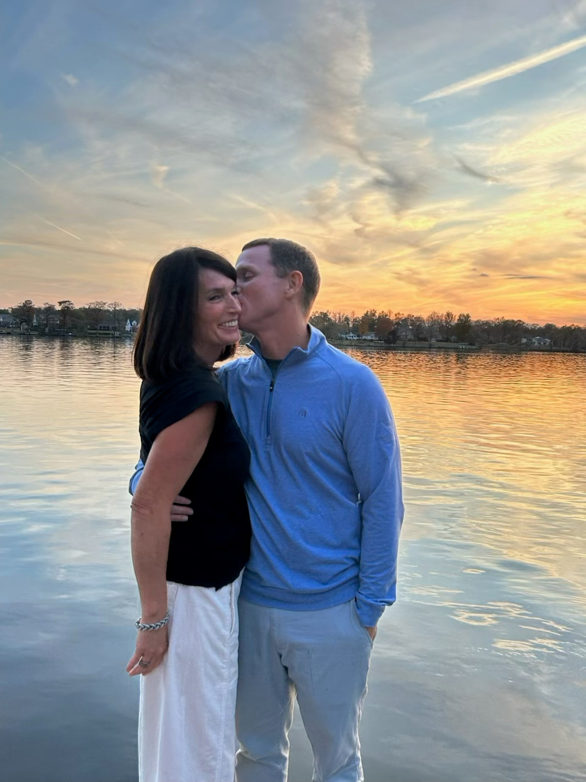 Garrett and April on a dock at sunset
